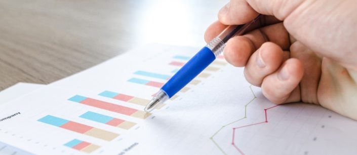 Man showing business graph on wood table